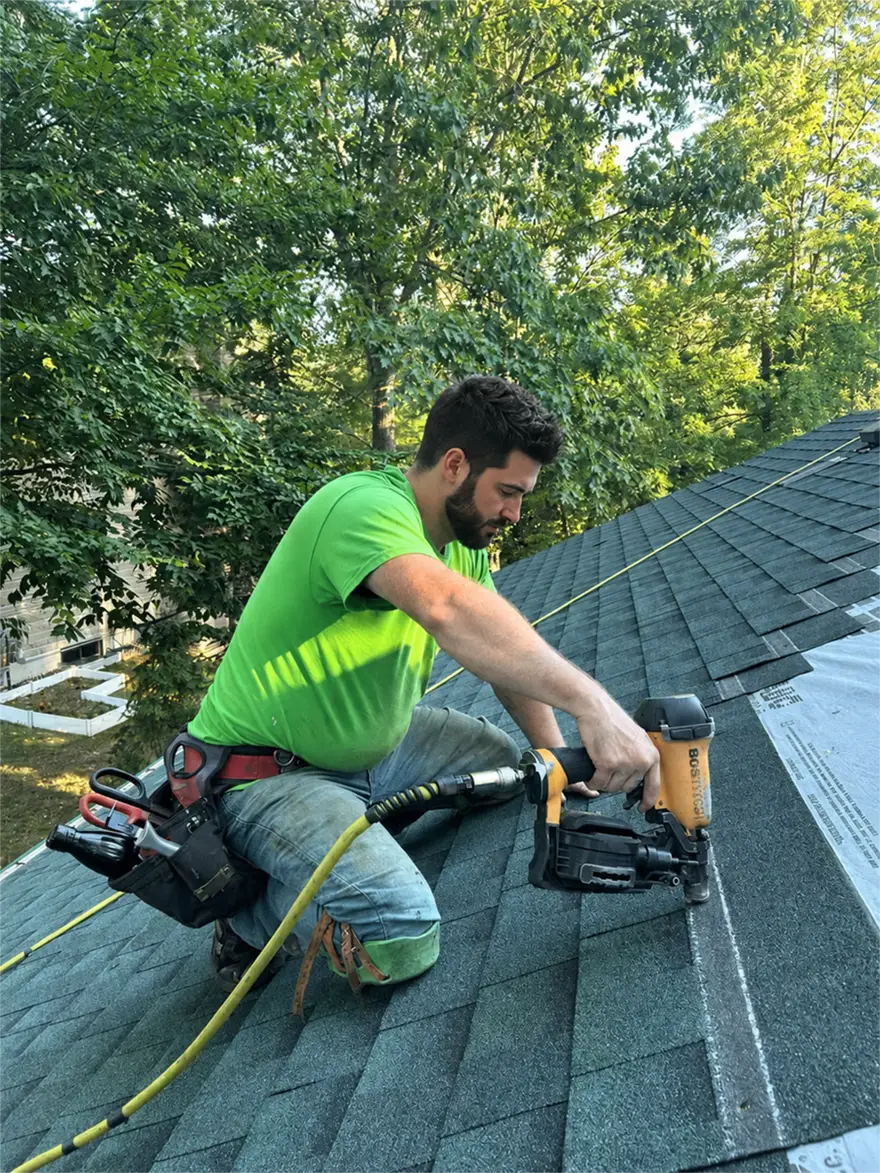Professional roofing contractor installing asphalt shingles on residential home in Ottawa