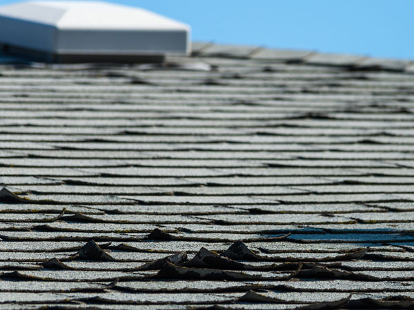Old roof shingles. Old and curled asphalt roof shingles