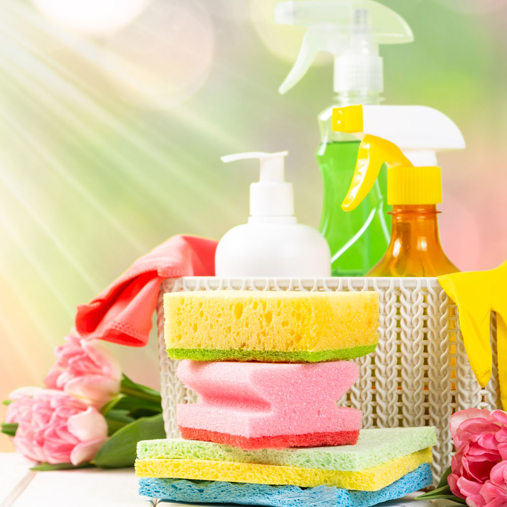 Spring cleaning concept - cleaning products, gloves, bokeh background, copy space